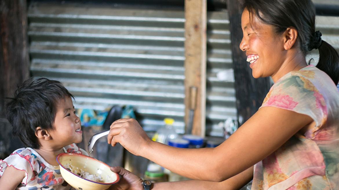 A mother is feeding her two years old daughter (photo taken in Chin State by Jennifer Hardy/CRS) A mother is feeding her two years old daughter (photo taken in Chin State by Jennifer Hardy/CRS)